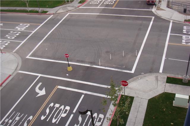 Road striping with STOP legends at a Thesta intersection